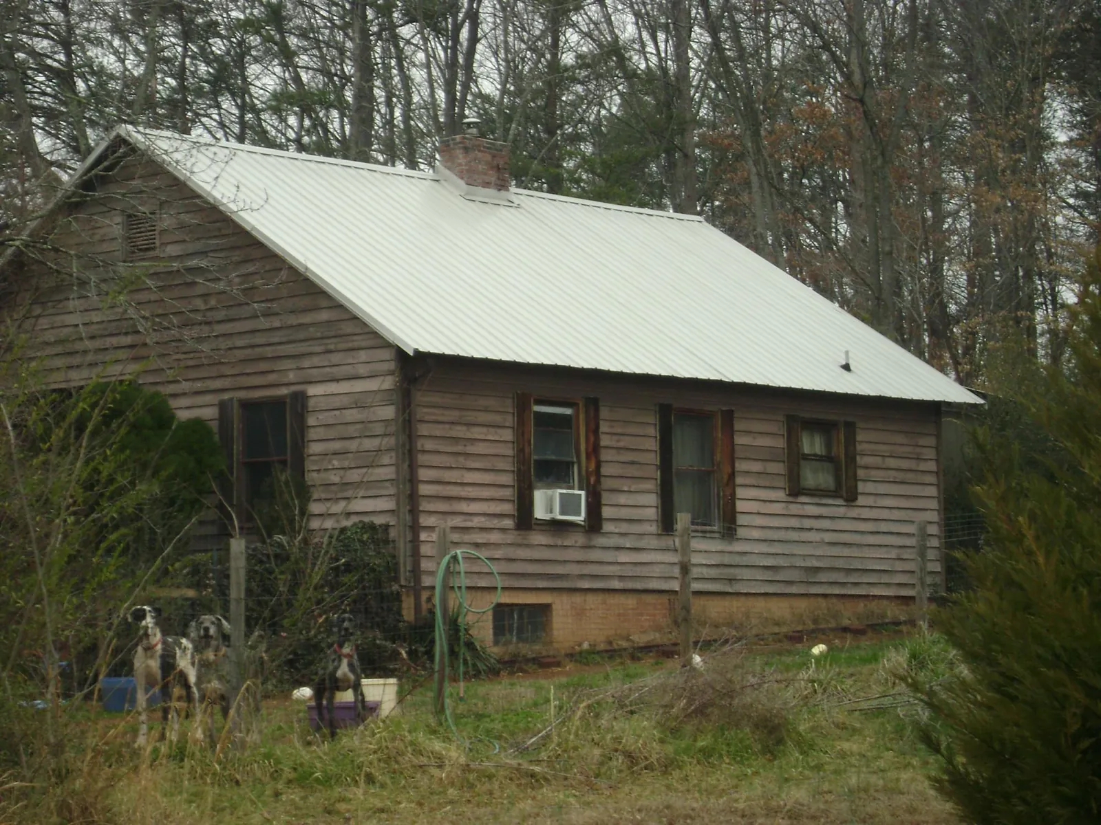 White metal roof on an old wood sided farmhouse, from a Metal Roof Installation job in Fossil
